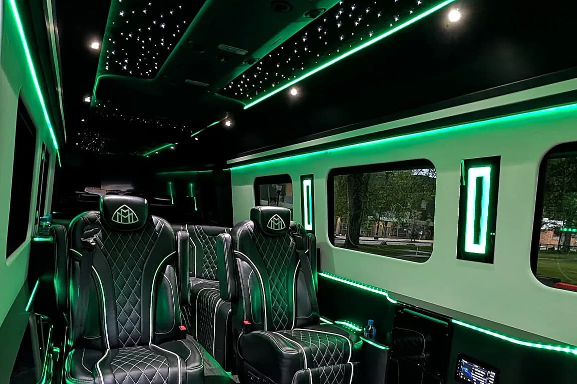 VIP Lounge Sprinter cabin with starlight ceiling and green accent lighting — Marquee Chauffeur fleet